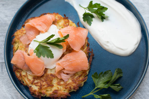 istock Fried draniki with red salted fish and poached egg. A dish decorated with herbs and sour cream 1394402076