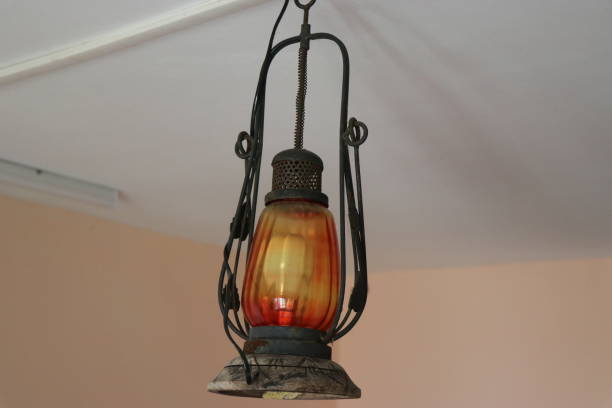 istock Antique type electric lantern hanging on the ceiling, Old and dusty lanterns modified into electrical type 1394402896