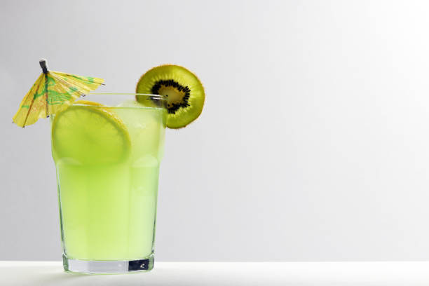Lemon, ice a little umbrella and a slice of kivi.