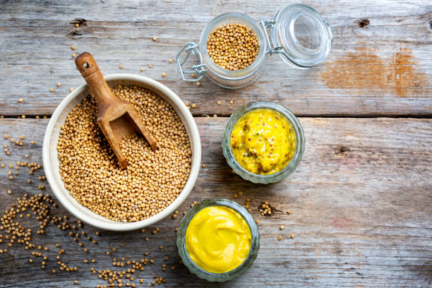 istock Different types of mustard and mustard seeds on a rustic wooden board 1394405888