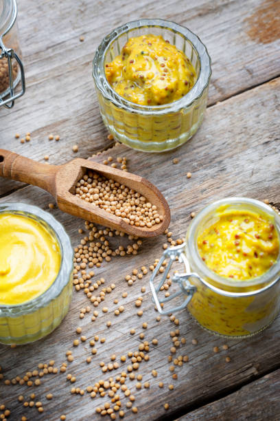istock Different types of mustard and mustard seeds on a rustic wooden board 1394405898