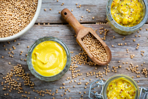 istock Different types of mustard and mustard seeds on a rustic wooden board 1394405907