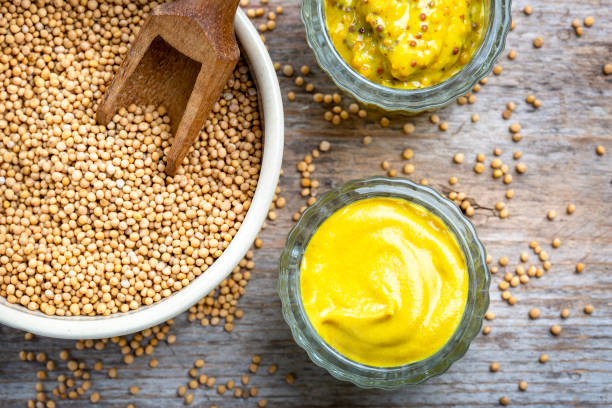 istock Different types of mustard and mustard seeds on a rustic wooden board 1394406412