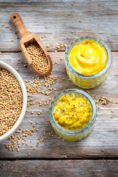 istock Different types of mustard and mustard seeds on a rustic wooden board 1394406416