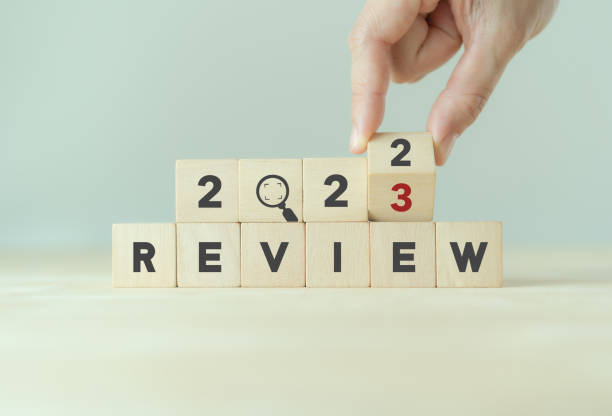 istock 2023 Review concept. For business planning. Hand flips a wooden cube and changes the inscription 'Review 2022' to 'Review 2023'. Beautiful grey background, copy space. Successful resolution strategy. 1394406965