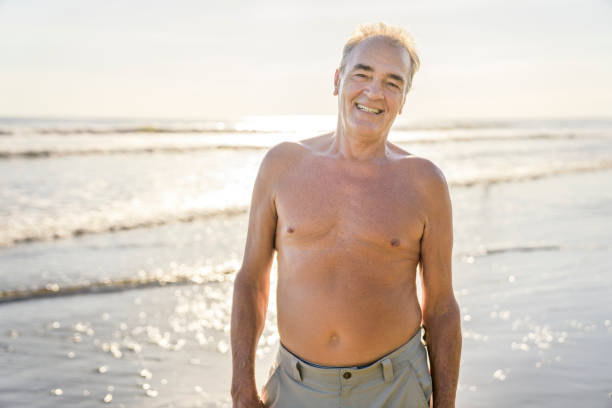 istock Senior men having great time on beach at the sunset 1394407599