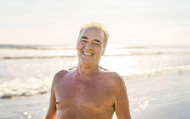 istock Senior men having great time on beach at the sunset 1394407606