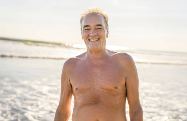 istock Senior men having great time on beach at the sunset 1394407609