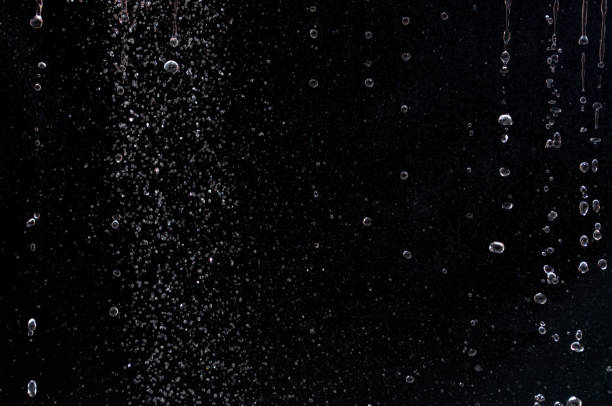 istock air bubbles in the water isolated on black background . 1394407636