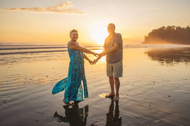 istock Senior Couple Enjoying Beautiful Sunset on the Beach 1394407678
