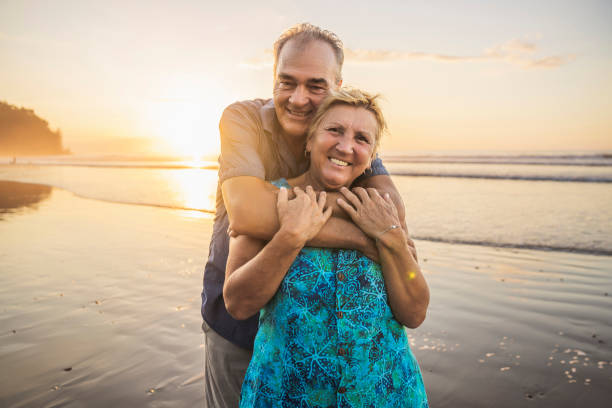 istock Senior Couple Enjoying Beautiful Sunset on the Beach 1394407699