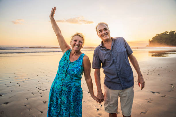 istock Senior Couple Enjoying Beautiful Sunset on the Beach 1394407798