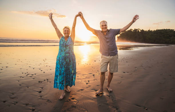 istock Senior Couple Enjoying Beautiful Sunset on the Beach 1394407799