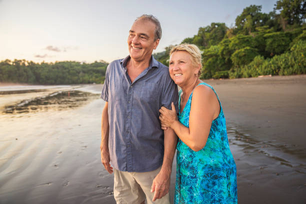 istock Senior Couple Enjoying Beautiful Sunset on the Beach 1394408429