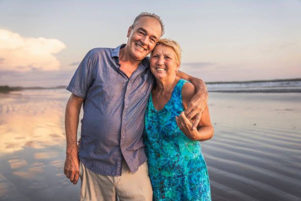 istock Senior Couple Enjoying Beautiful Sunset on the Beach 1394408942