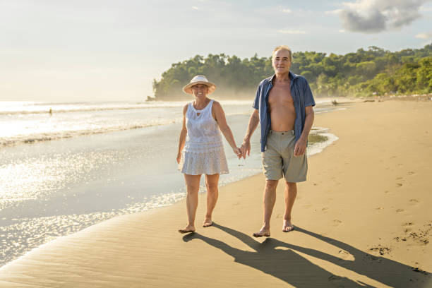 istock Senior Couple Enjoying Beautiful Sunset on the Beach 1394408976