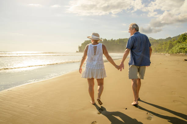 istock Senior Couple Enjoying Beautiful Sunset on the Beach 1394408982