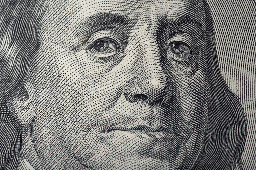 Portrait of Ben Franklin on the US 100 dollar bill in macro. Benjamin Franklin on hundred dollar American banknote.