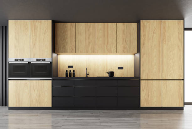 istock Matte black kitchen with natural oak wood on one wall 1394409148