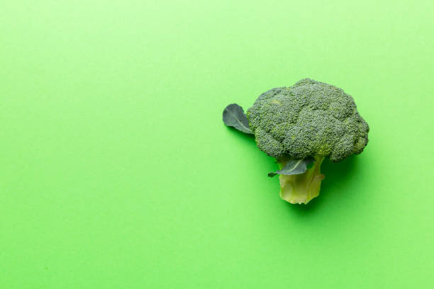 istock Top view fresh green broccoli vegetable on Colored background. Broccoli cabbage head Healthy or vegetarian food concept. Flat lay. Copy space 1394409931