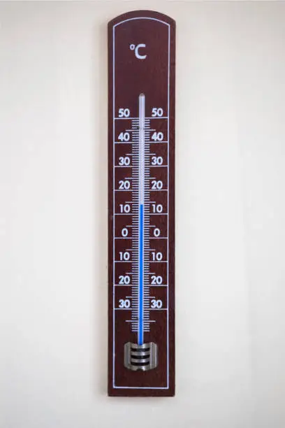 Photo of wooden thermometer with blue colored liquid