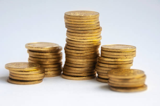 istock Gold coins stacked on white background. Finance concept 1394410950