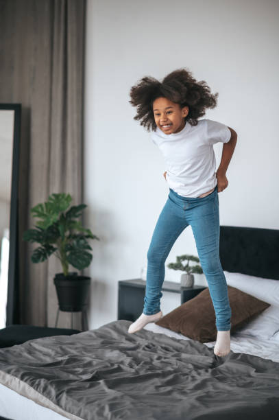 istock A cute curly-haired girl having fun and looking enjoyed 1394411286