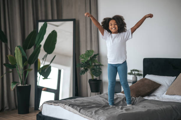 istock A cute curly-haired girl having fun and looking enjoyed 1394411294