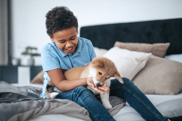 istock A boy having fun with his dog and looking excited 1394411402