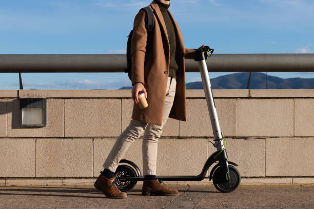 istock Unrecognizable young bussinesman using electric scooter as alternative, transport and renewable energy, eco friendly 1394411920