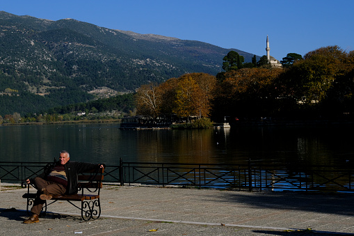 People enjoy the sunny day in Lake Pamvotida. Ioannina, Greece on November 21, 2021.