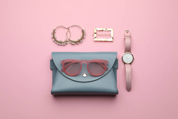 istock Stylish woman's bag and accessories on pink background, flat lay 1394413535