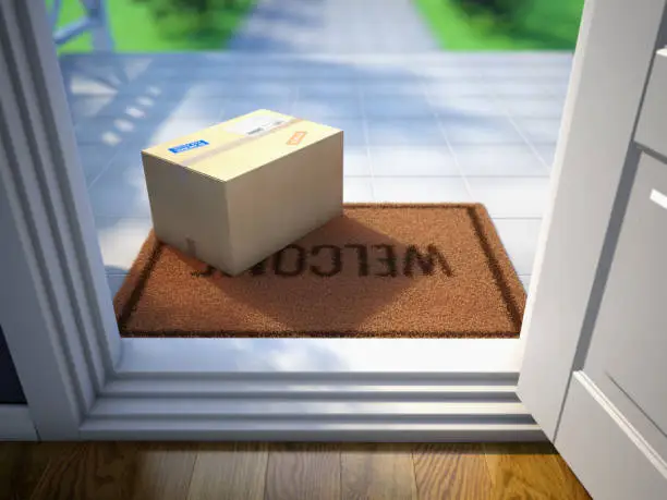 Photo of Cardboard parcel box delivered outside the door. Parcel on the door mat near entrance door. Online purchase delivery concept. 3d rendering