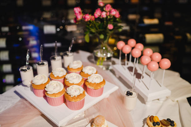 istock Candy bar with cupcakes and cake pops and different desserts at restaurant reception. 1394414998