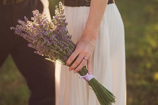 Bouquet of lavender flowers in girl's hands. Love, relationships, travel, romance concept.