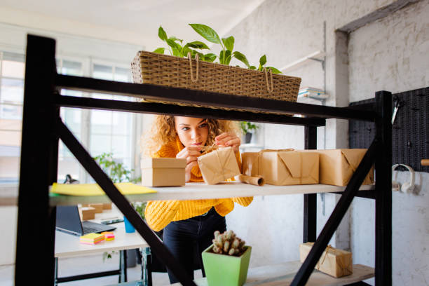istock Young woman packing boxes for customers 1394416435