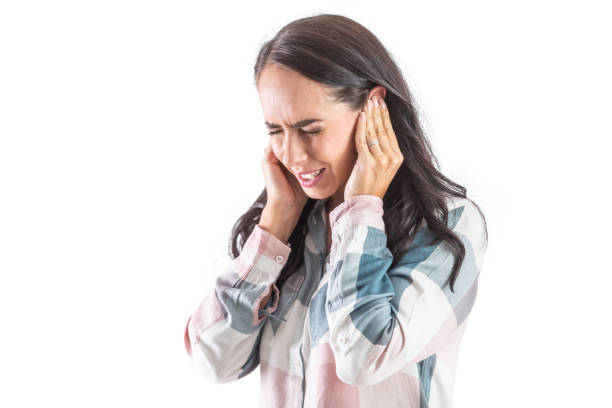 Young woman have tinnitus,noise whistling in her ears. stock photo