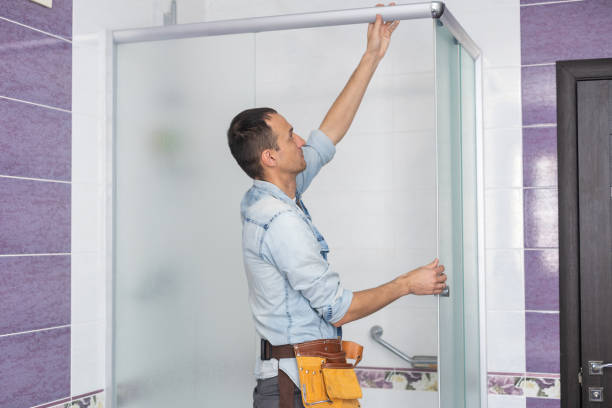 istock Plumber installing a shower cabin in bathroom. 1394417648