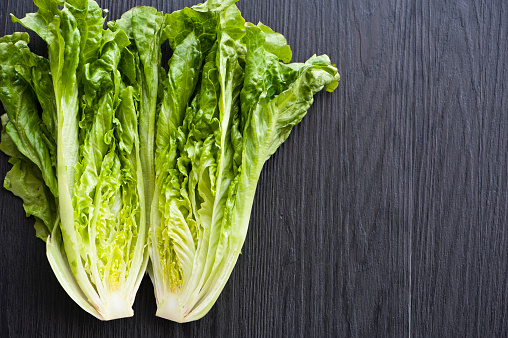 close up of fresh lettuce on wooden background