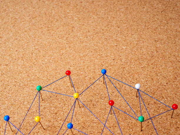 istock Networking. Linking entities. Social media. Communication. Networked. Web of blue wire on a cork background 1394421703