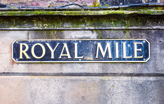 An old sign for the Royal Mile, one of the most famous locations in Edinburgh, located in the heart of the city's Old Town.