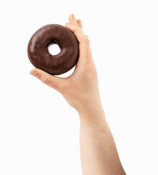istock woman holding a chocolate donut 1394427979