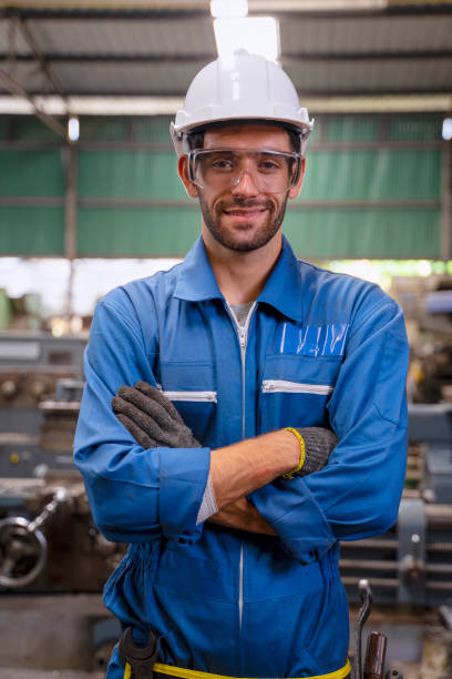 istock Blue collar worker with co worker at factory. 1394431512