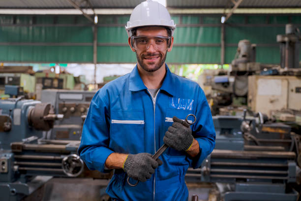istock Blue collar worker with co worker at factory. 1394431515
