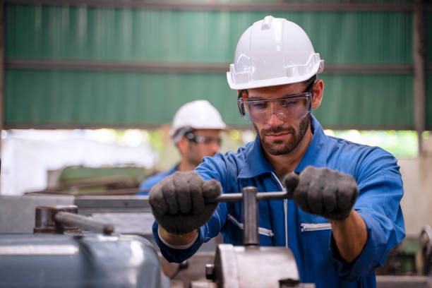 istock Blue collar worker with co worker at factory. 1394431519