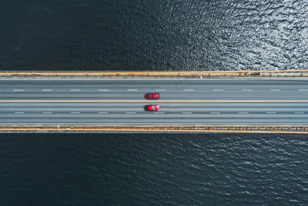 Photo of Red Cars Crossing Bridge