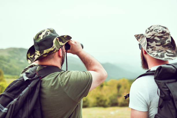 Two Bearded Male Watching The Mountain View Using Binoculars
