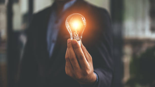 istock Hand holding a light bulb. Innovative concept with inspiration and energy saving concept. 1394437393