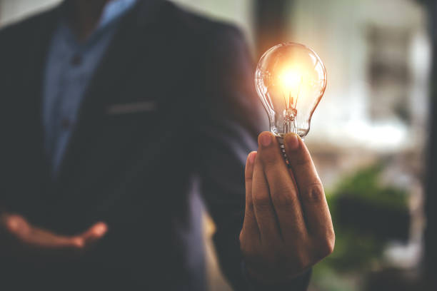 istock Hand holding a light bulb. Innovative concept with inspiration and energy saving concept. 1394437409