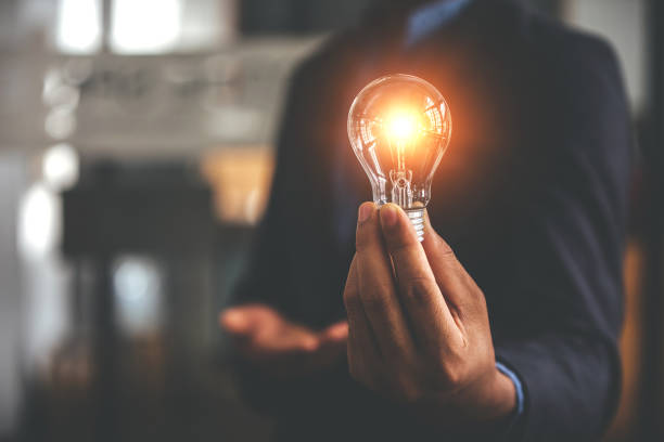 istock Hand holding a light bulb. Innovative concept with inspiration and energy saving concept. 1394437410